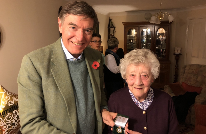 Philip Dunne MP presenting the Women’s Land Army badge to June Lee